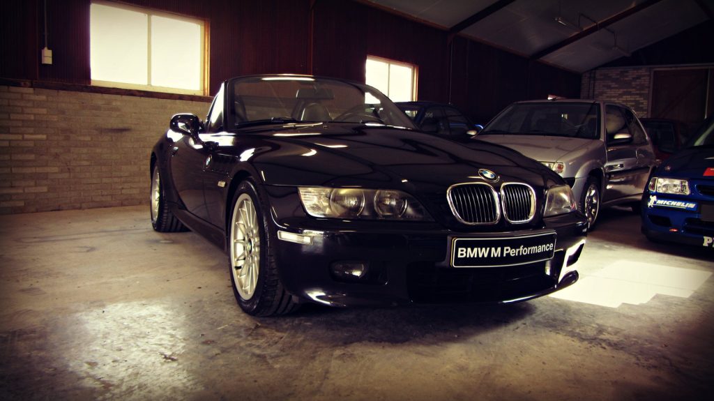 BMW Z3 2.8 Roadster (M-Sportfahrwerk), driekwart van voren tegen een donkere gevel
