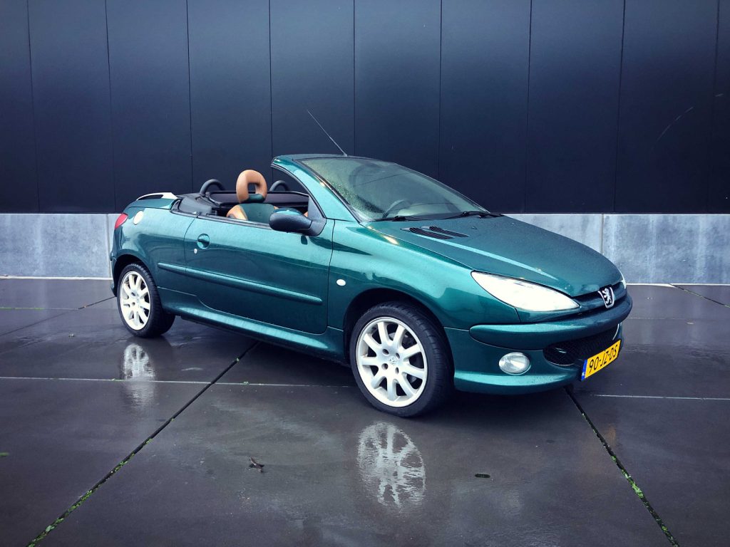 Peugeot 206 CC Roland Garros 1.6 16V, driekwart van voren tegen een donkere gevel